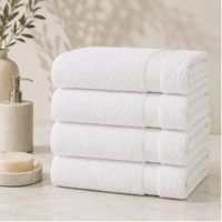 Stack of white towels on a bathroom counter with a neutral background