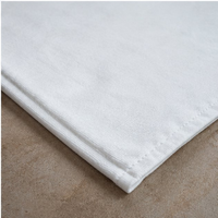 White bathmat on a brown surface