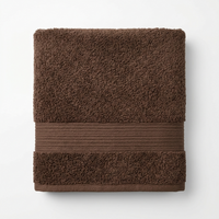 A folded brown cotton hand towel with a textured terry top, a ribbed middle band, and a plush border, shown on a clean white background.